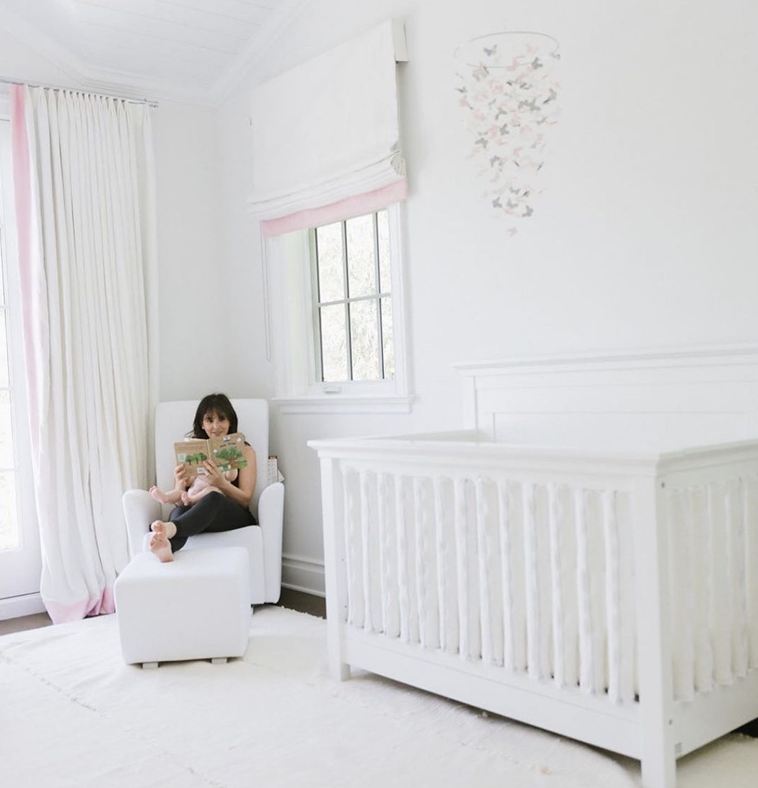 Nursery Crib With Pink Accent Trim And White Spindle Crib Style
