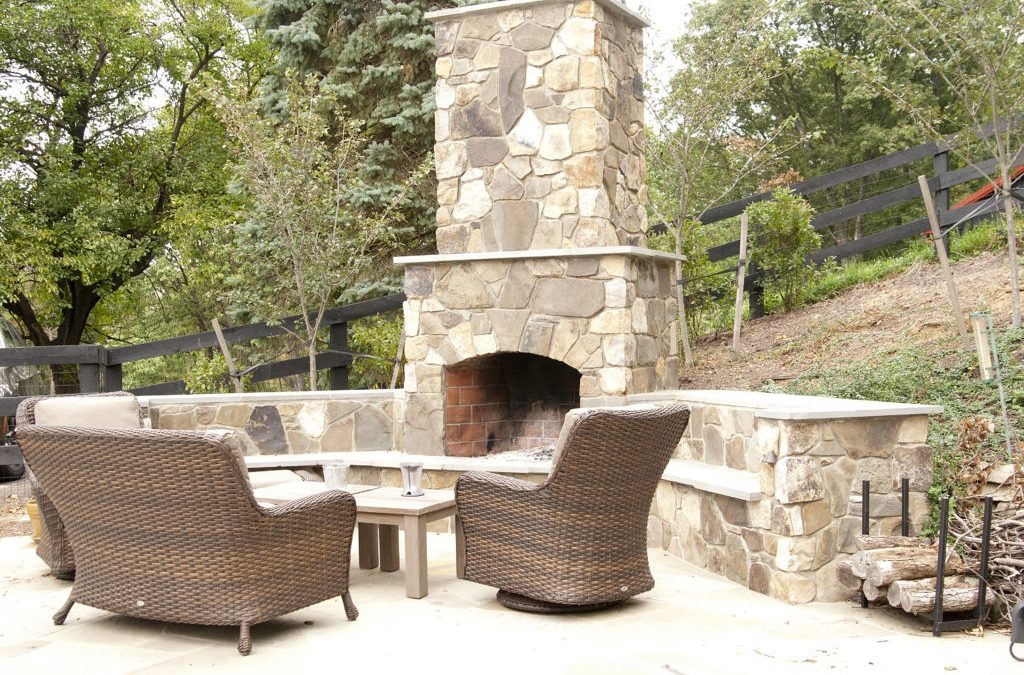 Outdoor Fireplace Tiered Chimney and Woven Patio Armchairs