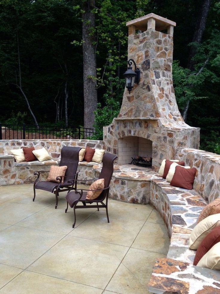 Outdoor Fireplace with Curved Stone Bench and Mounted Lantern