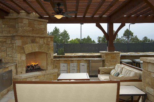 Outdoor Living Room with Slatted Pergola and Built-in Grill