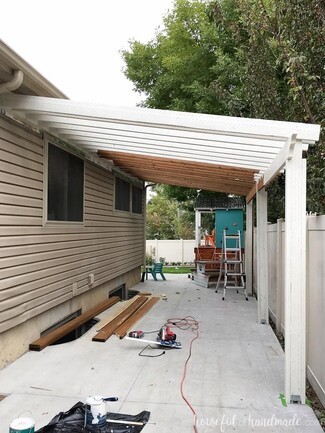 Patio Pergola With Slatted Wood Canopy and Wall Attachment