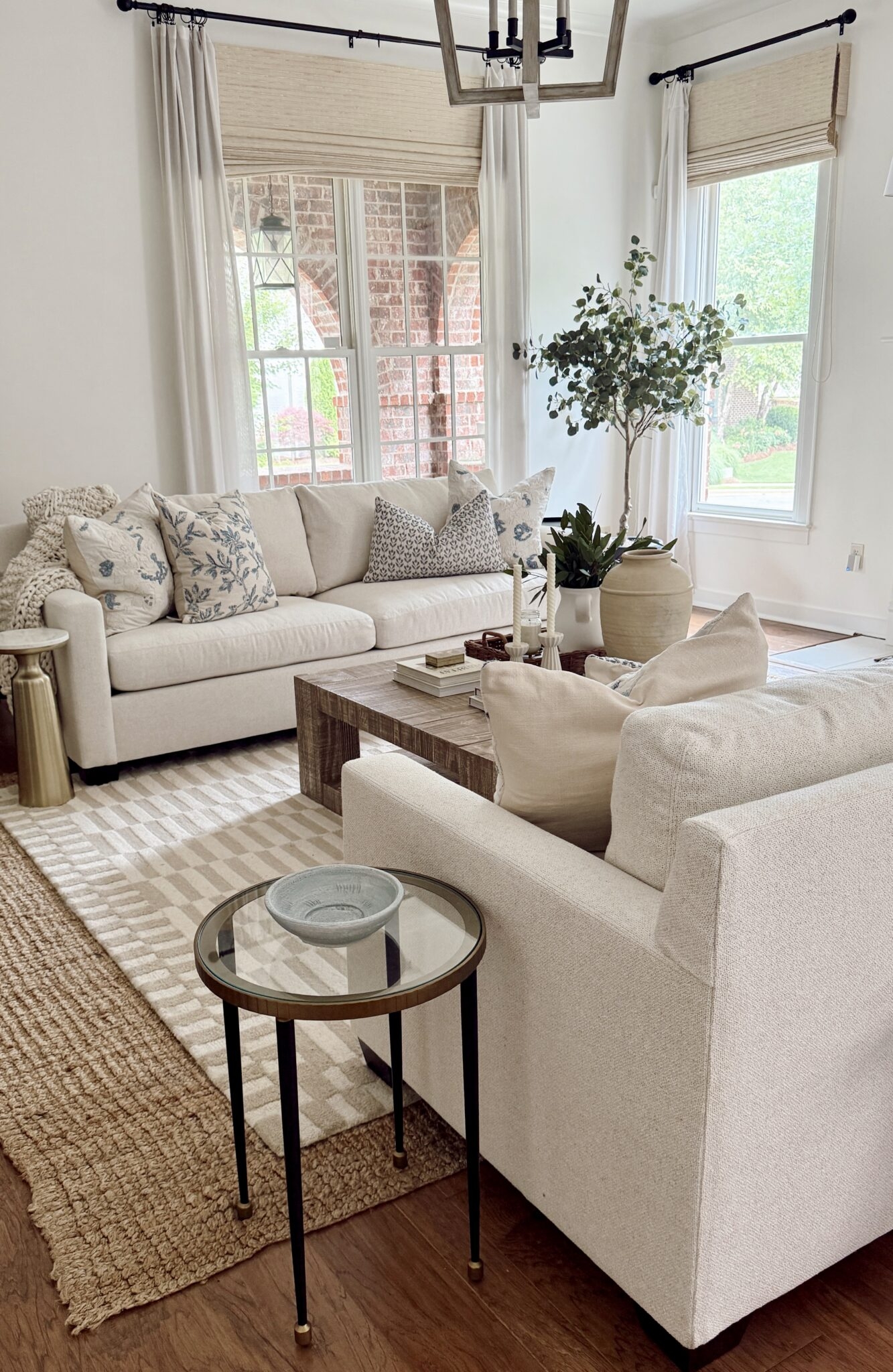 Upholstered Sofa with Sloped Arms and Layered Rugs