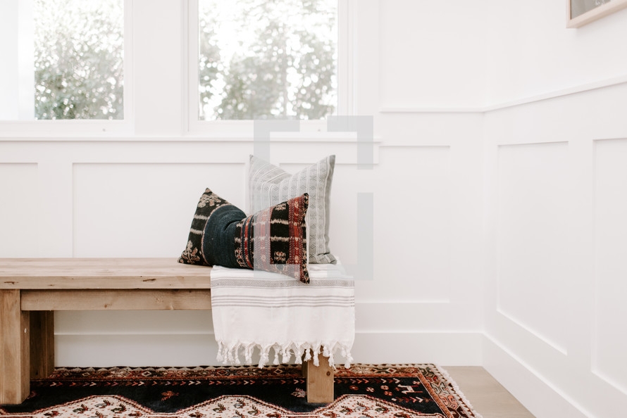 Wooden Bench with Kilim Pillows and Paneled Wainscoting